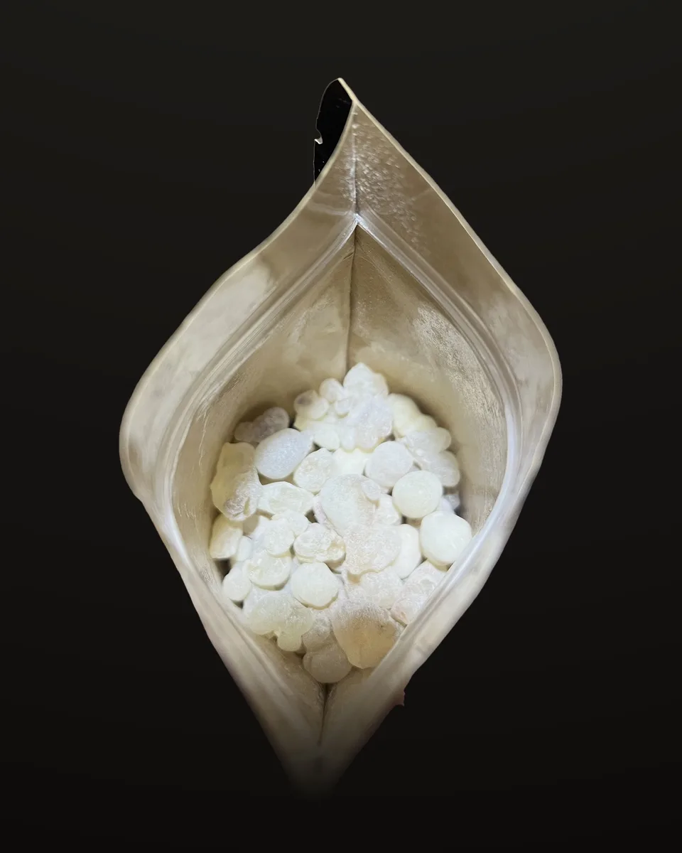 Looking down into an open pouch, full of pale Hojari tears